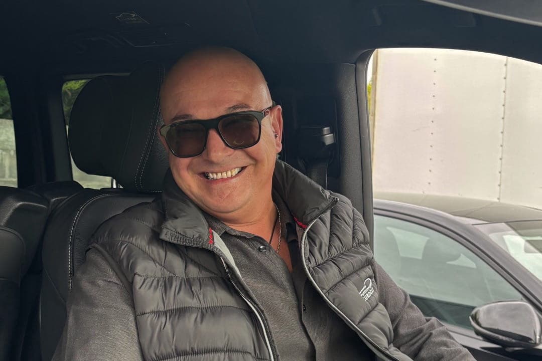 Chauffeur EuroCab souriant au volant d'un van noir
